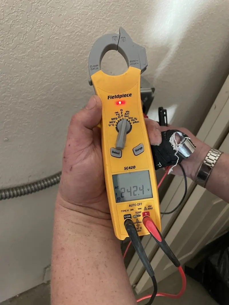 Voltage testing with clamp meter during Recessed Lighting Installation in Vilonia